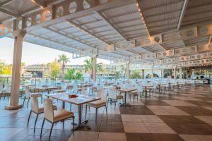 a dining hall with tables and chairs in a building at Crystal Prestige Elite in Kemer