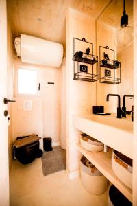 a small bathroom with a sink and a toilet at BUQEZ ECO RESORT - Beach Villa 12 - Nice view in Drage