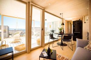 a living room with a large sliding glass door at BUQEZ ECO RESORT - Beach Villa 12 - Nice view in Drage +36 photos