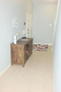 a hallway with a wooden desk in a room at Spacious Home, Short Walk to Beach, Heated Pool! in Corpus Christi