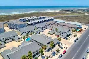 an aerial view of a building with the ocean in the background at Spacious Home, Short Walk to Beach, Heated Pool! in Corpus Christi