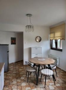 a kitchen and dining room with a table and chairs at Kouros Studios in Kavála +18 photos