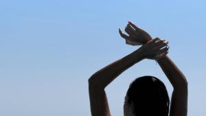 een vrouw met haar handen in de lucht bij Anima SeaView Luxury Living Villa, By ThinkVilla in Gázion