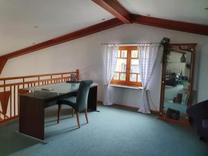 a living room with a desk and a window at Ferienhaus Panorama in Rechnitz