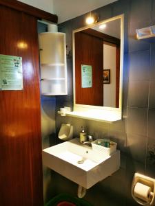 a bathroom with a sink and a mirror at Felicita in Paleokastritsa