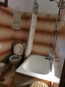 a bathroom with a bath tub and a toilet at Felicita in Paleokastritsa