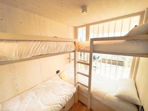 a small room with two bunk beds and a window at BUQEZ ECO RESORT - Beach Villa 81 - 1st Sea Line by beach in Drage