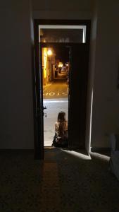 a child sitting in the doorway of an open door at Civico Otto7 in Villasimius +11 photos