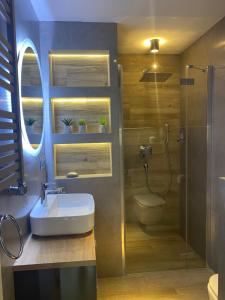 a bathroom with a sink and a shower at MazuryDreamHouse in Pelnik
