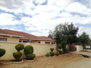 a house with bushes in front of it at DEN VIEW GUESTHOUSE in Francistown