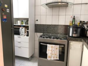 a kitchen with a stove with a towel on the oven at Charmosa suíte com vista lateral mar ! in Rio de Janeiro