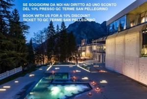 a swimming pool in front of a building at night at B&B San Pellegrino Terme in Zogno