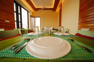 a table with a plate on top of it at The Abhyudyam Ganga in Haridwār