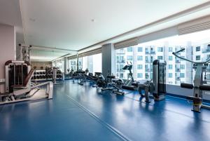 a gym with treadmills and machines in a building at Rare XXXL Swimming Pools Resort - Free Fast WIFI - Top Floor Pool View Balcony in Pattaya South