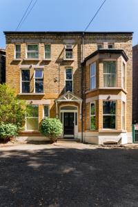 a brick house with a driveway in front of it at FLATZY - Lovely Sefton Park Retreat in Liverpool