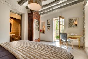 a bedroom with a large bed and a table at Château de Candes - Art & Spa in Candes-Saint-Martin +162 photos