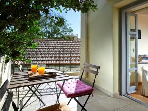 a table and chairs on a balcony with orange juice at Boutique Hotel Fortino in Chania +38 photos