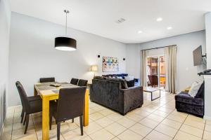 a living room with a table and a couch at Modern Retreat at Regal Oaks Resort in Orlando