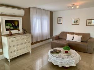 a living room with a couch and a table at Apartamento Manfroi in Bento Gonçalves