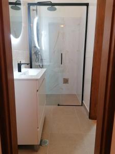 a bathroom with a shower and a sink and a toilet at Lotamar19 in Manta Rota +34 photos