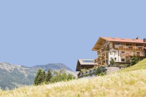 a building on the side of a hill at Hohenegg Apartment Karolina in Campolasta