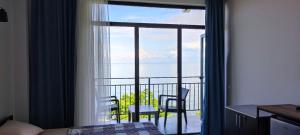 a room with a window with a view of the ocean at Guest house Garden Beach in Batumi
