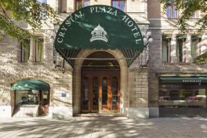 a building with a green awning in front of it at Crystal Plaza Hotel in Stockholm