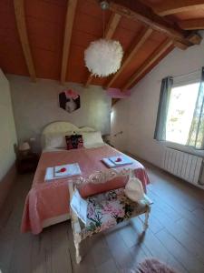 a bedroom with a bed and a chandelier at Notte Rosa Suites & Relax in Fornovo di Taro