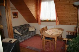 a living room with a table and a couch at Zur Rotenfelsstube in Traisen