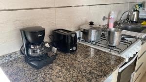 a kitchen counter with a coffee maker and a blender at Altos San Martín in Concepción del Uruguay