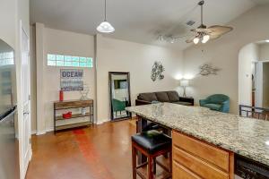 a kitchen and living room with a bar and a couch at Marquesas #310 in Padre Island