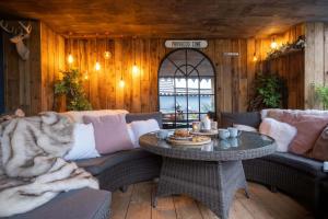 a living room with a couch and a table at Deer Lodge in Lymington
