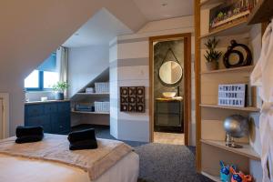 a bedroom with a large bed and a mirror at Deer Lodge in Lymington +62 photos