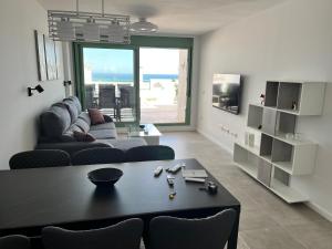 a living room with a couch and a table at Lovely New Luxery Beach Apartment in Mojacar Playa in Mojácar