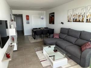 モハカルにあるLovely New Luxery Beach Apartment in Mojacar Playaのリビングルーム(ソファ、テーブル付)
