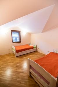 a bedroom with two beds and a window at Boka Apartment in Baošići +16 photos