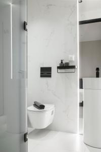 a white bathroom with a toilet and a shower at Ultra Chic Modern 4 Bedrooms Apartment in Athens in Athens
