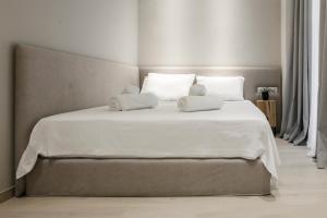 a bedroom with a large white bed with two pillows at Ultra Chic Modern 4 Bedrooms Apartment in Athens in Athens