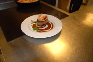 a white plate with a dessert on a table at Aparthotel Edy Bruggmann AG in Flumserberg