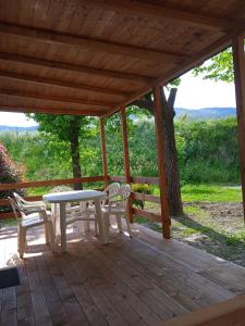 a patio with a table and chairs on a deck at Mobile home Ameglia - Including airco - Camping River- 328 in Ameglia