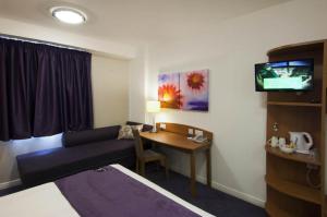 a hotel room with a television and a bed at Premier Inn London Gatwick Airport - North Terminal in Crawley