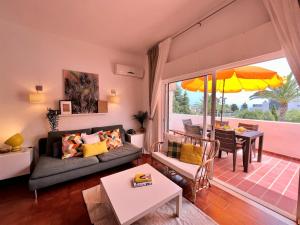 a living room with a couch and a table at Armação de Pêra Twins 2 With Pool by Homing in Armação de Pêra