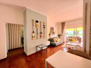 a living room with a couch and a table at Armação de Pêra Twins 2 With Pool by Homing in Armação de Pêra +24 photos
