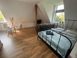 a bedroom with a bed and a table and chairs at Apartament Willa Bellevue in Rabka-Zdrój