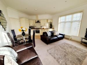 a living room with a couch and a table at Vitamin Sea Beachfront Apartment Ramsgate - Sleeps 4 in Ramsgate