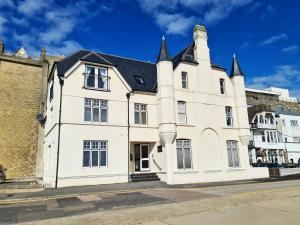 a large white building with a black roof at Vitamin Sea Beachfront Apartment Ramsgate - Sleeps 4 in Ramsgate