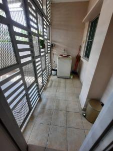 an empty hallway with a refrigerator in a house at HOMESTAY DR. Z (MUSLIM HOMESTAY) in Klang