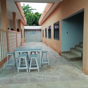 a picnic table and stools outside of a building at Bethel House 2 Villas in Abomey-Calavi