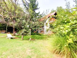 a garden with a bench in front of a house at Impeccable apartment with view in Dolna Matka in Skopje