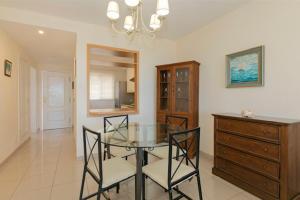 a dining room with a glass table and chairs at Apartamento Sara en el Veril del Duque - Sara Vacation in Adeje